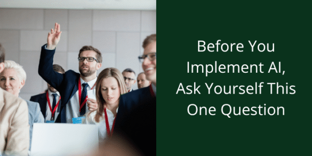 before you implement AI ask yourself one question. Person in a business setting raising hand.