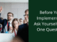 before you implement AI ask yourself one question. Person in a business setting raising hand.